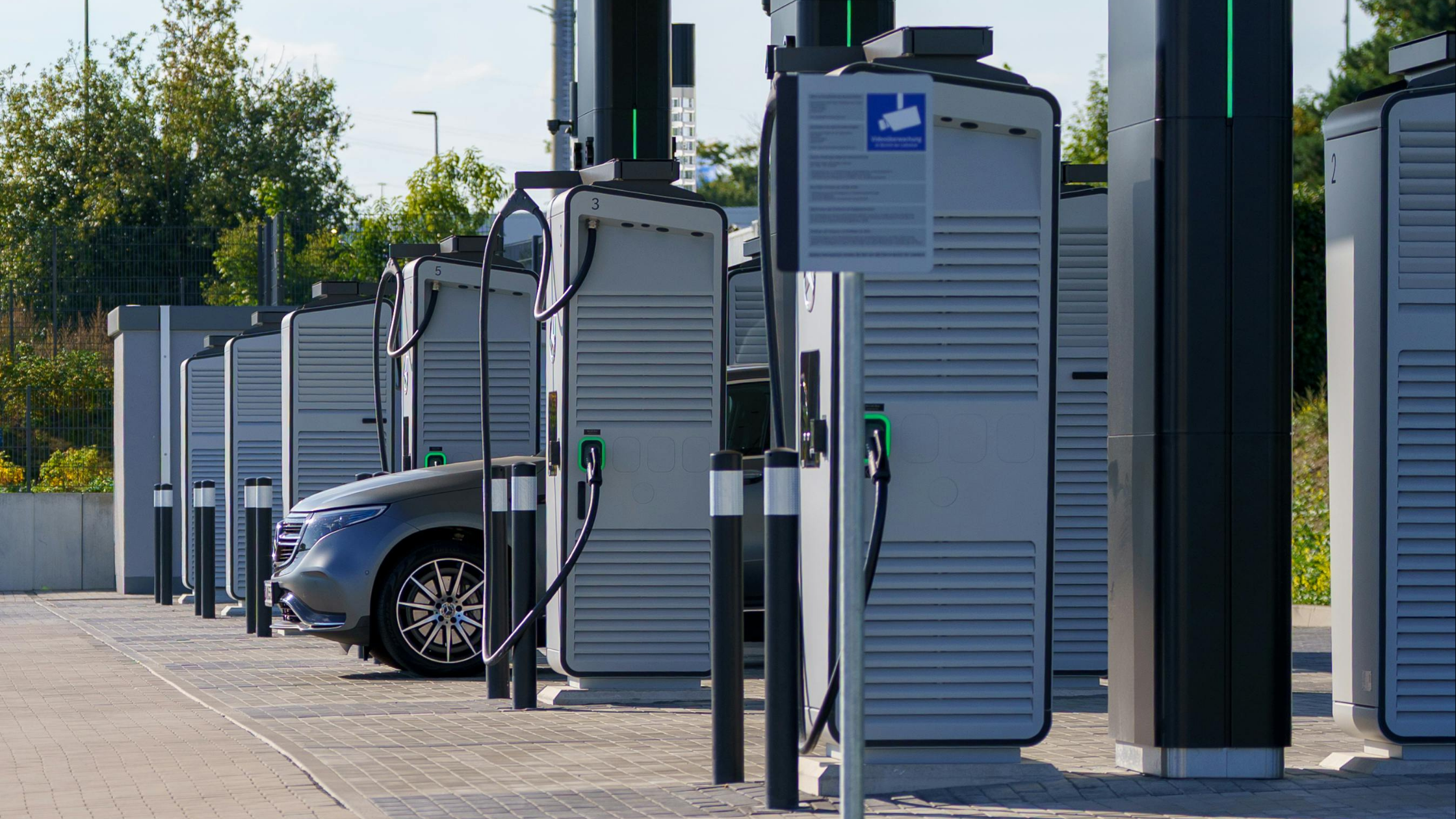 Row of commercial EV charging stations at a public charging site, representing EV charger internal power supply and grid-connected infrastructure.